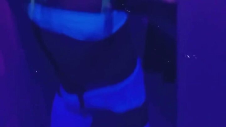 Dancing in rave lingerie at a blacklight party